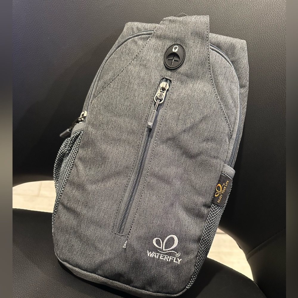 Waterfly crossbody sling backpack dark grey
